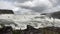 Fantastic waterfall in landscape of Iceland with rocks and grass