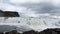 Fantastic waterfall in landscape of Iceland with rocks and grass