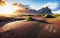 Fantastic west of the mountains and volcanic lava sand dunes on the beach Stokksness, Iceland.