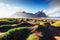 Fantastic west of the mountains and volcanic lava sand dunes on the beach Stokksness, Iceland.