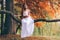 Fantastic young woman. beautiful fantasy girl fairy with white long dress in windy autumn park