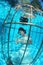 Fantasy bride underwater in a bird cage