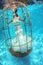 Fantasy bride underwater in a bird cage