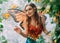 fantasy happy woman fairy walks in jungle. Pixie girl in carnival costume bright orange monarch butterfly wings. Red