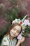 Fantasy little girl with rainbow unicorn horn with flowers in azalea park