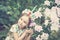 Fantasy little girl with rainbow unicorn horn with flowers in azalea park. for Halloween.