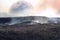 Fantasy of the surface of another planet with charred and charred earth and smoke with a view of the moon