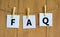 FAQ frequently asked questions symbol. Concept words FAQ frequently asked questions on white papers on a beautiful wooden