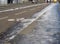 Far away jogger running on partly frozen city bicycle lanes