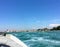A faraway view of a boat approaching Venice on a sunny summer day. The view is from someone in a water taxi