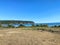 A faraway view of a crowded beach with people visiting and enjoying the waters of Tribune Bay