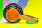 Farberware plastic measuring cups on a colorful background.
