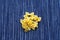 Farfalle macaroni A handful of macaroni on a rustic striped white blue textured background. A view from the top, a close