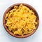 Farfalle macaroni pasta in wooden bowl on white isolated background in the center close-up with top.