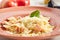 Farfalle pasta al dente with salmon in cream sauce