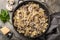 Farfalle pasta with champignon mushrooms and garlic creamy sauce on pan