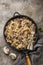 Farfalle pasta with champignon mushrooms and garlic creamy sauce on pan