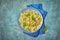 Farfalle pasta with pesto sauce and basil