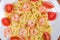 Farfalle pasta with shrimp tails and cherry tomatoes, top view