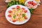 Farfalle pasta with shrimp tails and tomatoes against the ingredients