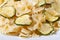 Farfalle pasta with zucchini and cheese on a white plate macro
