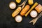 Farinaceous food. Fresh bread and raw pasta near flour in bowl and wheat ears on black background top view space for