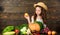 Farm activities for kids. Girl kid farm market with fall harvest. Kid farmer with harvest wooden background. Family farm