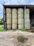 Farm bales stacked high in a old tin barn