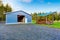 Farm blue barn shed and gravel driveway.