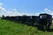 Farm with a Bunch of Parked Amish Buggies in a Field