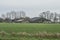 Farm with cow stables, silos and silage pile