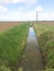 Farm drainage ditch. Rainwater run-off. Arable farmland.