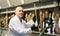 Farm employee operating machine milking in in cows barn