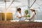 Farm entrepreneur checking quality of hydroponic vegetables product before harvest and sell to customer