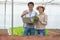 Farm entrepreneur checking quality of hydroponic vegetables product before harvest and sell to customer