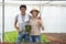 Farm entrepreneur checking quality of hydroponic vegetables product before harvest and sell to customer