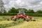 A farm fendt tractor with rota rake ready to make silage