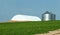 A farm Field and crop storage buildings,