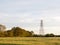 a farm field outside as the sunsets with a serene sky and a pylon wonderful and peaceful