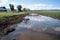 farm field, with water runoff and pollution visible along the shore