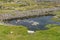 Farm fields with rock walls and lake in Inisheer Island