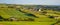 farm fields in the south of Ireland on a summer evening. Agricultural Irish landscape. Pastures for livestock, house on green