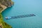 Farm fish cage for salmon growing in natural sea environment of fjord. Alesund, Nirway