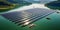 farm of floating solar panels on a pond in the mountains