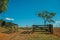 Farm gate with cattle guard and barbed wire fence