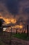 Farm gate with stormy sunset clouds in African landscape
