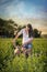 Farm girl and Weimaraner dogs in a green field