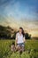 Farm girl and Weimaraner dogs in a green field