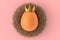 Farm gold egg with gold royal king crown in bird nest on pink background