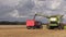 Farm harvester pour corn after threshing on blue sky background